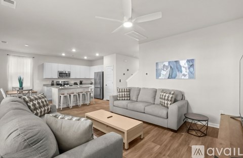A living room with a grey couch and a coffee table.
