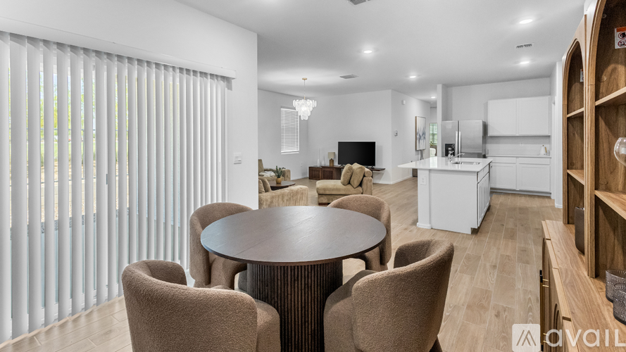 A modern dining room with a round table and chairs.