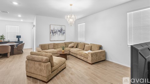 A living room with a large sectional sofa and a television.