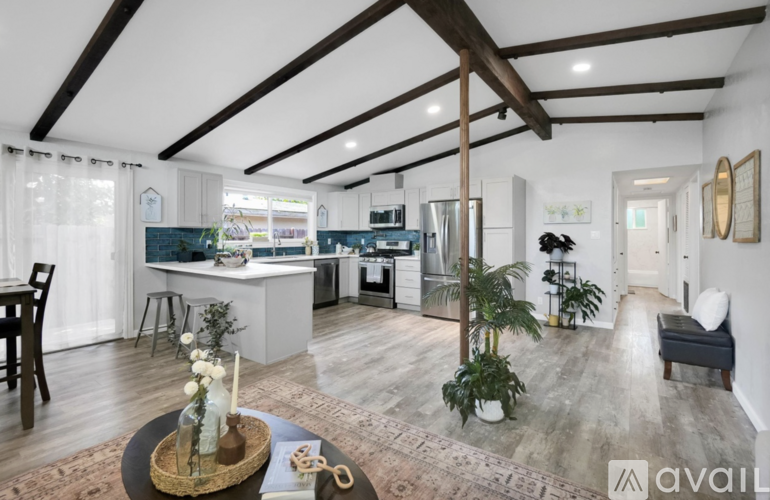A modern kitchen with a dining table and chairs.