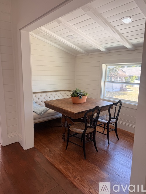 A dining room with a table and chairs.