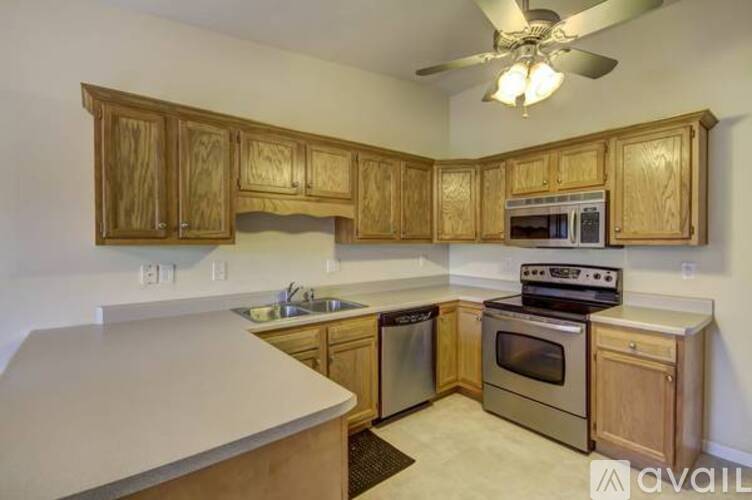 A kitchen with wooden cabinets and stainless steel appliances.