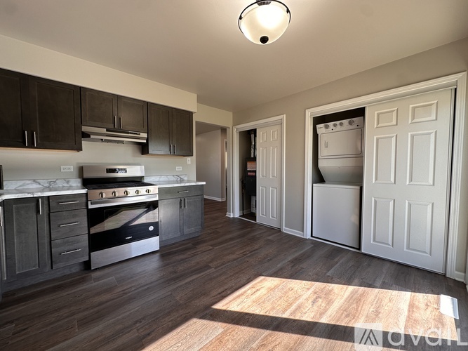 A kitchen with dark wood cabinets and a white oven.