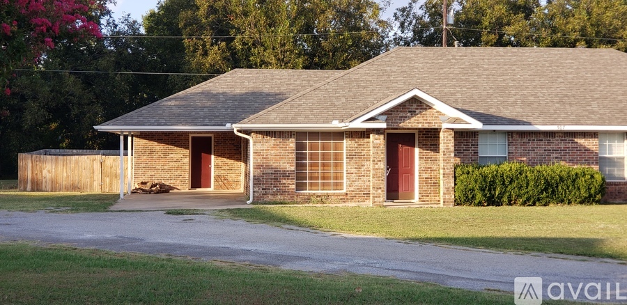 A house with a brown roof and a red door.