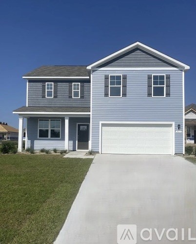 A two-story house with a garage is available for sale.