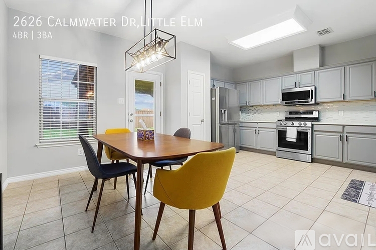 A modern kitchen with a dining table and chairs.