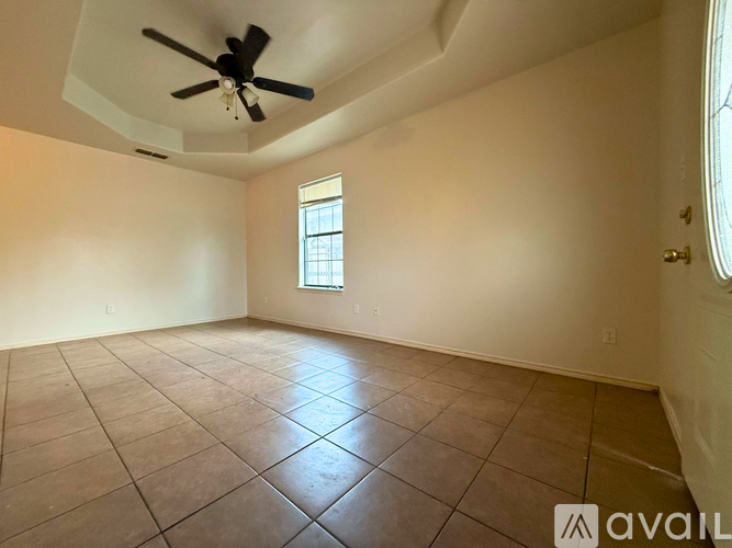 A room with a ceiling fan and tile flooring is available for rent.