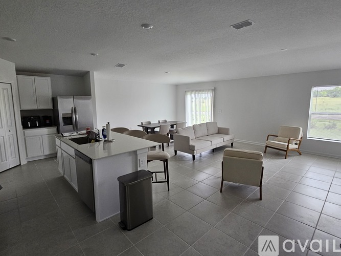 A kitchen with a dining table and chairs.