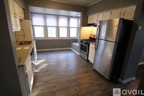 A kitchen with a refrigerator, stove, and oven.