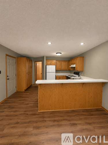 A kitchen with wooden cabinets and a white countertop.