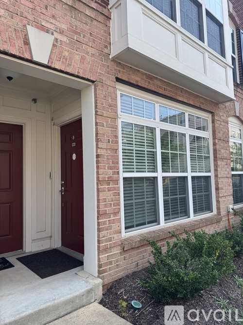 A house with a red door and a window with blinds.