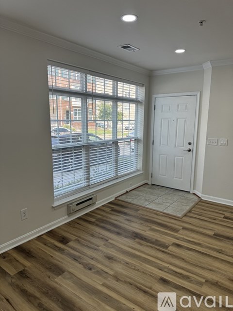 A room with wooden flooring and a white door.