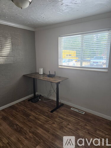 A room with a desk and a window.
