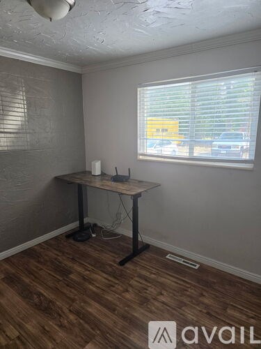 A room with a desk and a window.