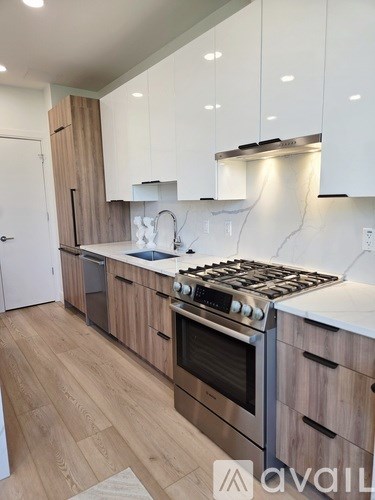 A kitchen with wooden cabinets and a stainless steel stove top.