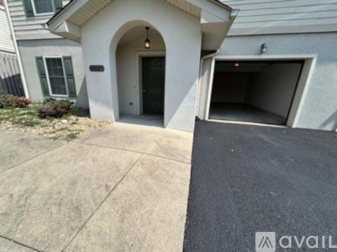A house with a garage and a driveway.
