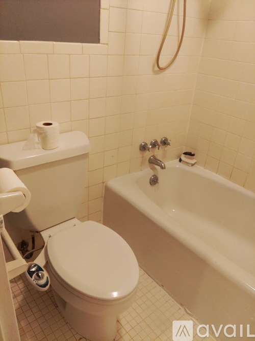 A white toilet and bathtub in a bathroom.