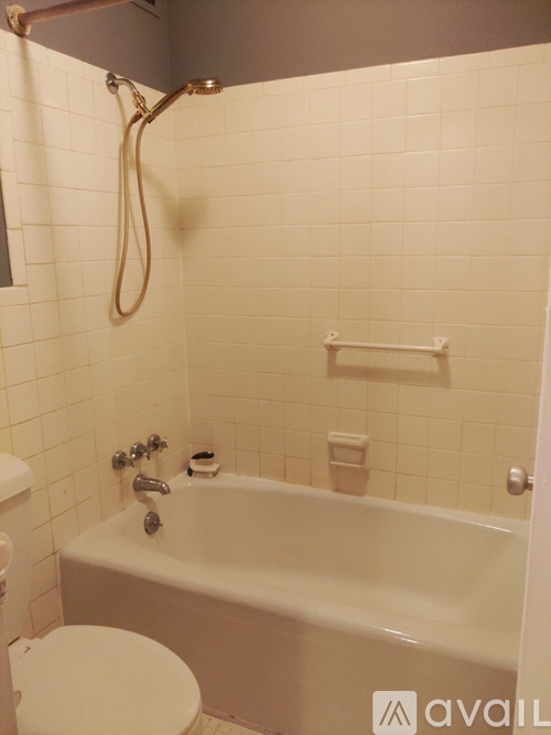 A white bathroom with a tub, toilet and sink.