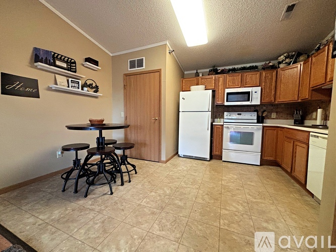A kitchen with a table and chairs in the middle of the room.
