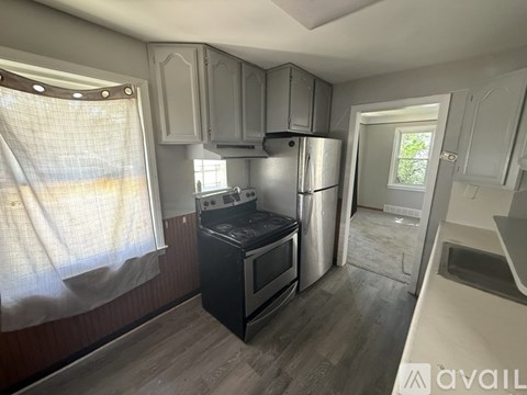 A kitchen with a black oven and stove top.