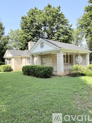 A house with a white front porch and a chimney.