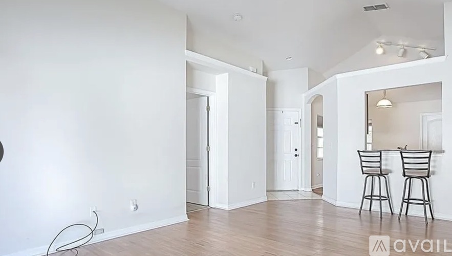 A room with a dining table and chairs in it.