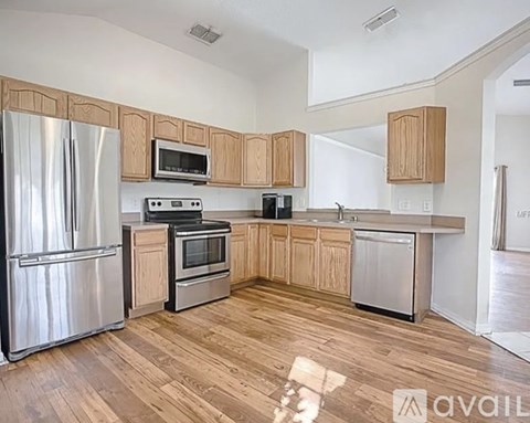 A kitchen with wooden cabinets and stainless steel appliances.