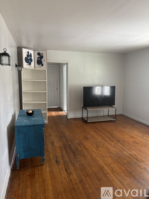 A room with a blue cabinet and a television set.