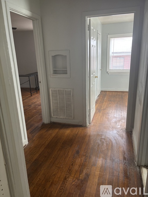 A room with wooden floors and white walls.
