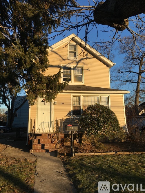 A house with a porch and a mailbox on the front.