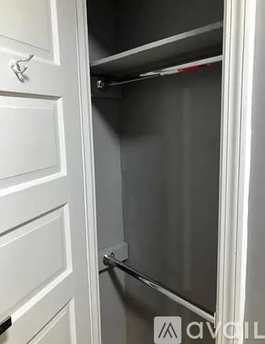 A white door with a handle and a silver bar on the inside.