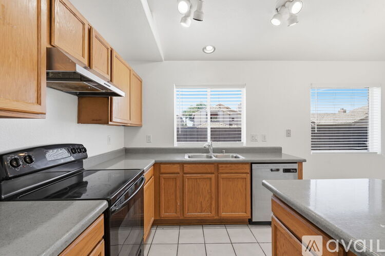 A kitchen with wooden cabinets and a black stove top oven.