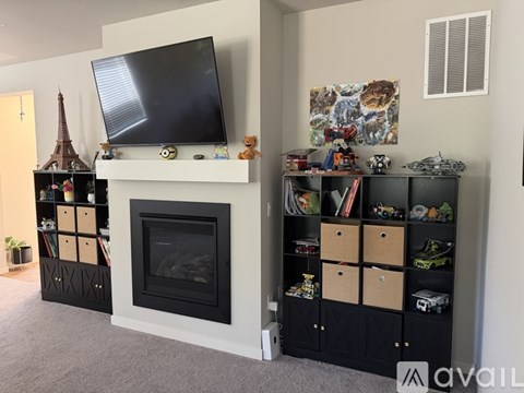 A living room with a fireplace and a television on top of it.