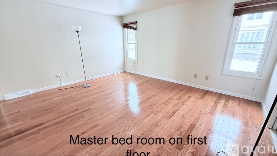 A large, empty master bedroom on the first floor.