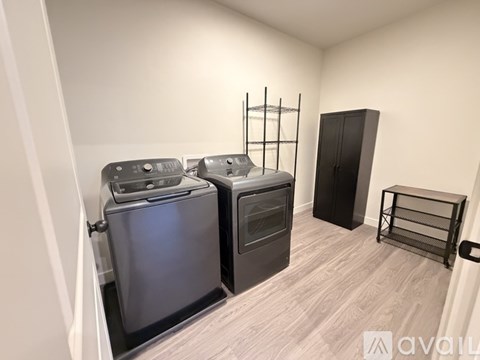 A kitchen area with two ovens and a black cabinet.