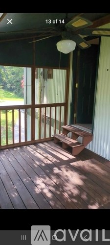 A wooden deck with a bench and a lamp.