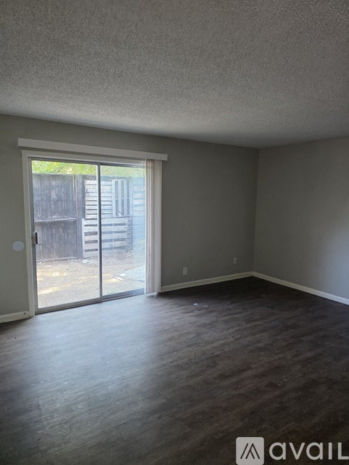 Empty room with a sliding glass door leading outside.