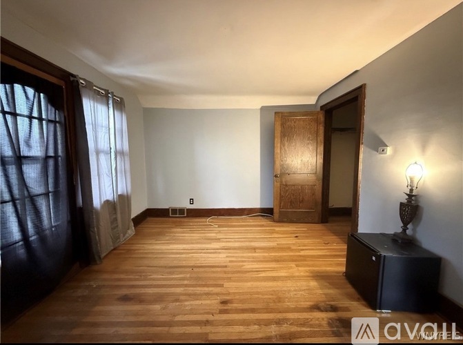 A room with wooden floors and a wooden door.