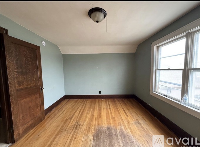 A room with wooden floors and a window.