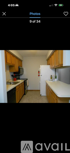 A kitchen with wooden cabinets and a white refrigerator.
