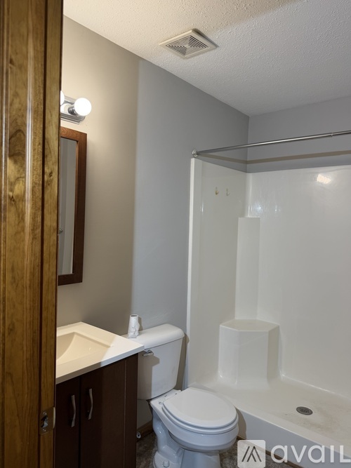 A bathroom with a toilet, sink, and bathtub.