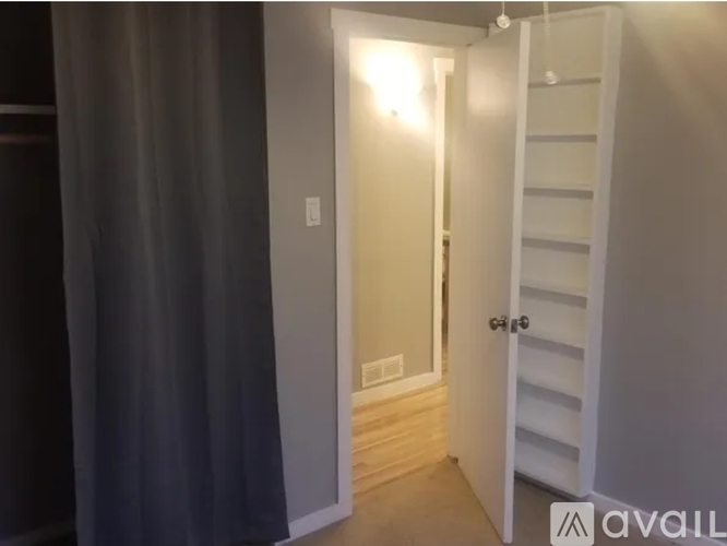 A white door is open to a hallway.