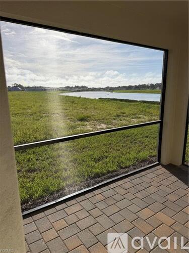 A view of a grassy field through a window.