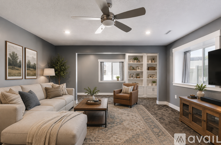 A living room with a white couch, a coffee table, and a ceiling fan.