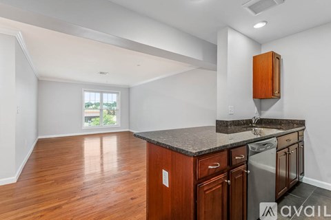 A kitchen with wooden cabinets and a granite countertop.