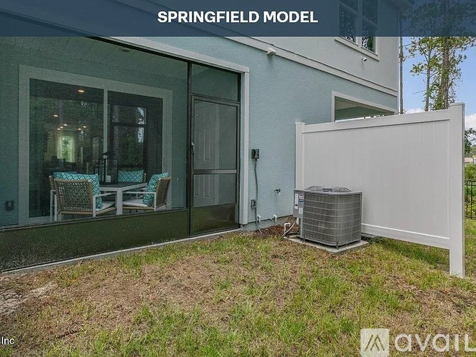 A Springfield Model house with a patio and a white fence.