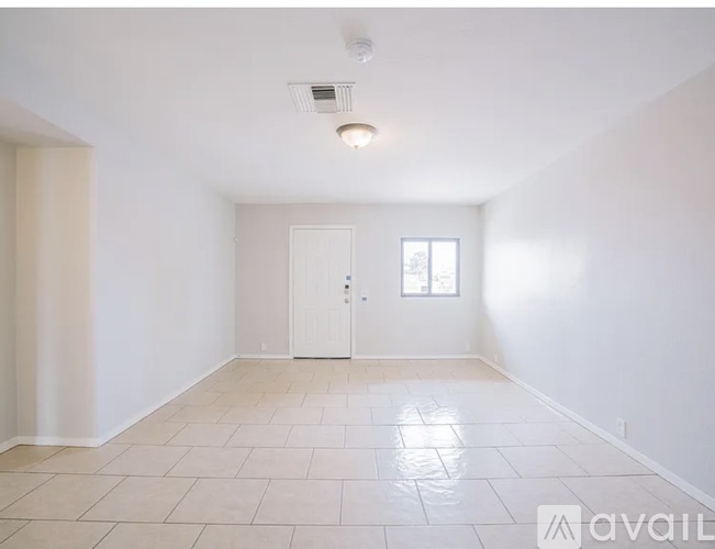 A spacious room with a door and a window.