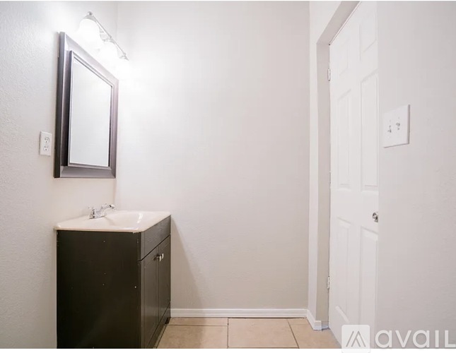 A bathroom with a sink and a mirror.