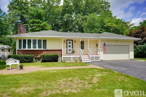 A house with a flag on the front porch is for sale.