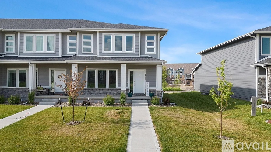 A house with a front yard and a walkway leading to the front door.